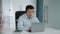 Professional mature asian man operator wearing headset video chatting with client via smartphone, consulting online