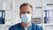 Professional medical doctor in hospital office, Portrait of young and confident physician in protective mask.