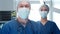 Professional medical doctors working in emergency medicine. Portrait of the surgeon and the nurse in protective masks.