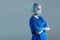 Professional medical worker in protection suit. Nurse, surgeon, doctor or paramedic in blue uniform. Emergency medicine