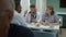 Professional medics talk while having dinner in clinic cafe