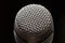 Professional microphone in a music studio on a black background. Record sounds and songs. Chrome metal microphone. Digital