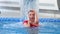 Professional model poses in swimming pool looking straight