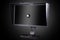 Professional monitor with shading hood and calibrator isolated on black