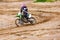 Professional Motocross Motorcycle Rider Drives Over the Road Track.