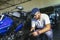 Professional motorcycle mechanic working in bike repair service