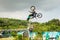 A professional motorcycle rider giving a free style motorcross acrobatics demonstration in Shenzhen Zoo park, in China