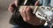 Professional musician playing guitar, close up view.