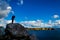 Professional nature photographer standing on a rock and taking photos of the breathtaking landscape of Brittany