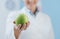 Professional nutritionist holding a fresh apple