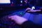 Professional online gamer hand fingers mechanical keyboard in neon color blur background. Soft focus, back view