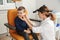 Professional otolaryngologist examining little boy in clinic