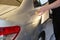 Professional Paintless Dent Repair Technician Is Repairing Dents On Car Body. Hands Of Car Mechanic. Process Of Removing