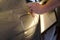 Professional Paintless Dent Repair Technician Is Repairing Dents On Car Body. Hands Of Car Mechanic. Process Of Removing