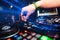 Professional panel DJ mixer with hand controlling mixing music in nightclub