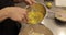 A professional pastry chef woman mixes eggs and adds them to a large bowl