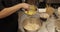 A professional pastry chef woman mixes eggs and adds them to a large bowl