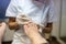 Professional pedicurist removing cuticle