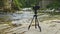 Professional photo camera mounted on tripod outdoors in moutain canyon