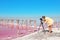 Professional photographer taking photo of pink lake