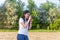 Professional photographer woman at work. selective focus. Taking pictures outdoors in the park. The brunette looks at the camera