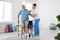 Professional physiotherapist working with senior patient