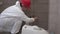 Professional plumber man preparing for toilet pan bowl mount in new bathroom