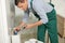 Professional plumber repairing toilet tank