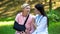 Professional podiatrist comforting injured old lady arm sling, recovery advise