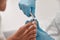 Professional podiatrist uses shny clipper to cut toenail of man in beauty salon