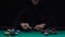 Professional poker player bluffing, making risky bet with smirk on face, slow-mo