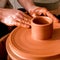 Professional potter making bowl in pottery workshop