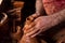 Professional potter making bowl in pottery workshop, studio