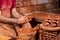 Professional potter making bowl in pottery workshop, studio