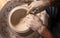 Professional potter making bowl in pottery workshop, studio