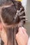 Professional process of hair extension for a woman with the help of artificial, in a beauty salon close up