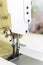professional production sewing machine close-up, leather production, seamstress