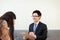 Professional psychologist talking with asian women patient,Therapist man conducting a consultation and counseling