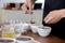 professional Q Grader preparing to test and inspecting the quality of coffee and skim off the coffee grounds from ceramic cup on