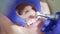 Professional removing teeth plaque in dental office. Close up teeth polishing