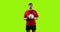 Professional rugby player standing and throwing a ball on green background 4k