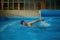 Professional senior man swimmer doing exercise in indoor swimming pool