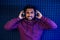 Professional singing indian men headphones sound modern studio violet background recording song. dj in nigt club.