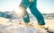 Professional skier leg at sunset on skiing slope mountain resort