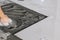 Professional and Skillful Male Tiler Tiling the iNdoor Granite Floor