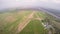 Professional skydiver fly in sky above green fields. Sunny day. Extreme. Scenery