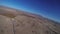 Professional skydiver parachuting above sandy country. Landscape. Landing. Sunny