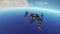 Professional skydivers parachuting above Dubai, dancing in sky. Ocean. Extreme