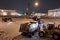 Professional snow removal equipment clearing Palace Square at night after intense snowfall in city