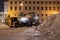 Professional snow removal equipment clearing Palace Square at night after intense snowfall in city